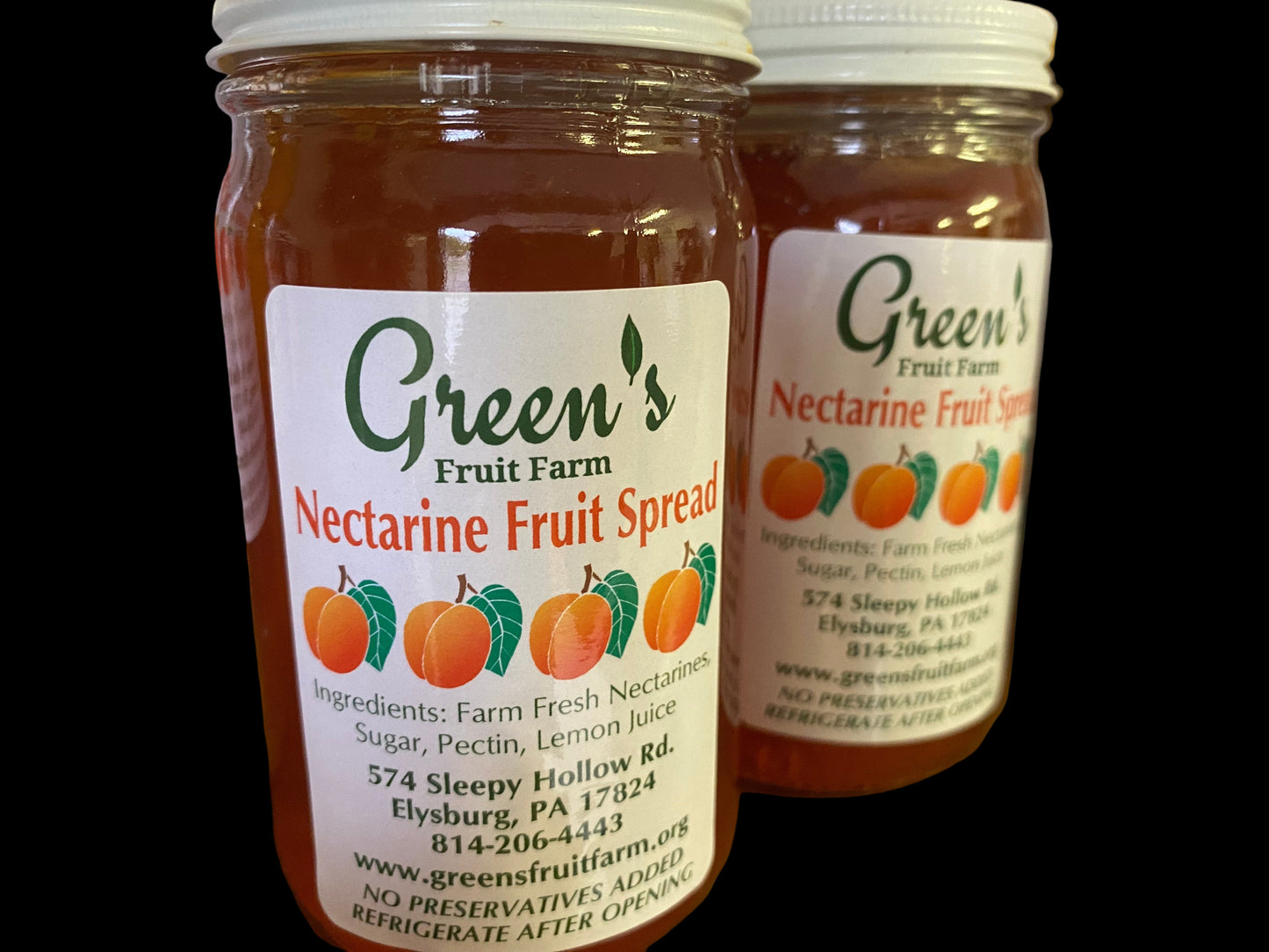 Jars of Green's Nectarine Fruit Spread on a wooden surface